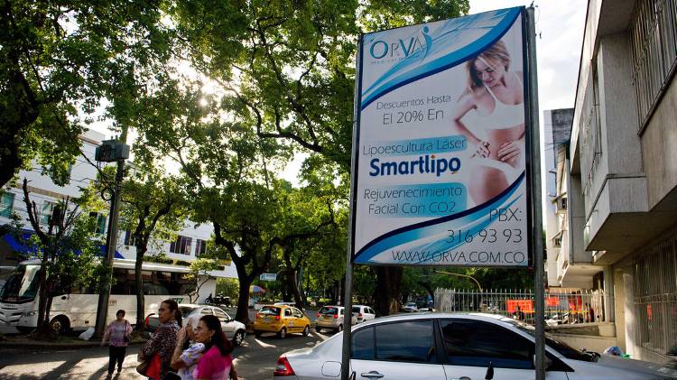 A billboard announces discounts on cosmetic treatments in a street of Cali, Valle del Cauca department, Colombia. In recent years the country has been building facilities specifically designed for medical tourists.