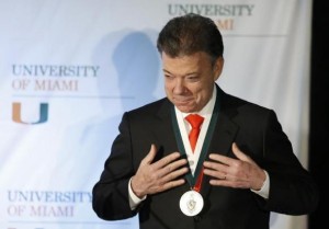 Colombia's President Juan Manuel Santos reacts after he received the 'President's Medal' from University of Miami President Donna Shalala during his visit to the University in Coral Gables, Florida December 2, 2013. 