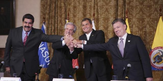 L-R) Venezuela's President Nicolas Maduro, Uruguay's President Tabare Vazquez, Ecuador's President Rafael Correa and Colombia's President Juan Santos hold hands after their meeting at the Carondelet Palace, in Quito, Ecuador in this handout picture provided by Miraflores... Reuters/Miraflores Palace/Handout via Reuters