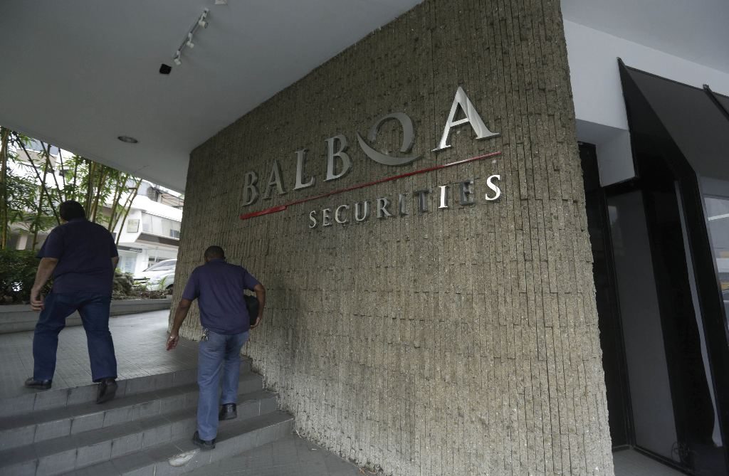 People walk outside the Balboa Bank & Trust Corp. building in Panama City, Thursday, May 5, 2016. Panama authorities took control of the Balboa Bank & Trust Corp. after U.S. officials announced the arrest of a Panama-based businessman who allegedly ran a worldwide money-laundering organization for drug traffickers. (AP Photo/Arnulfo Franco)