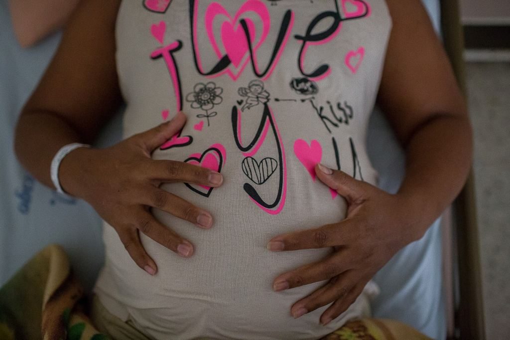 Gloria Golú, 41, holds her belly at University Hospital of Valle, in Cali, Colombia, last month. Golú is carrying her third child and is infected with the Zika virus. (Eduardo Leal/For The Washington Post)