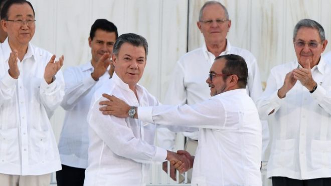 Colombia's President Santos, left, and the rebel leader known as Timochenko shook hands after signing the deal 