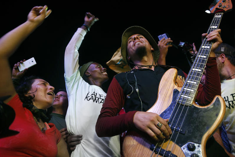 FARC members with guitarist Pablo Araoz of the Bogota reggae group Alerta Kamarad on the first night of the conference. It was the first concert some FARC members and residents had ever experienced.